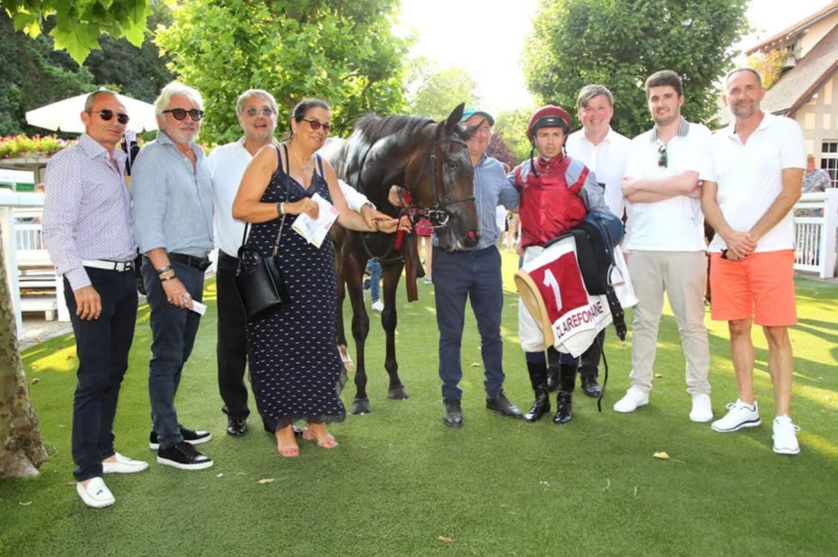 Owners and the team in the winner’s enclosure